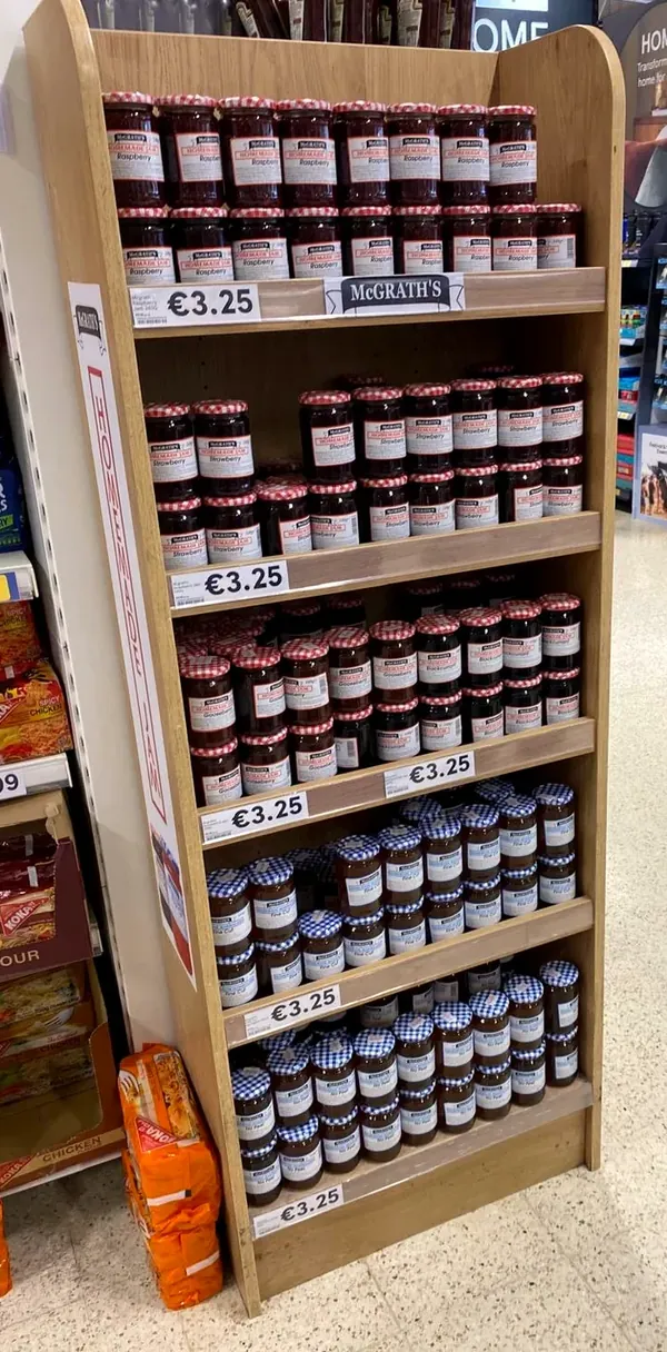A full retail shelf unit of McGrath’s jams and marmalades, every shelf stocked and priced